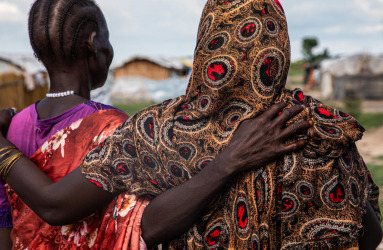 Two women look out within an IDP site in northern South Sudan, 2024. | Photo credit: Alioune Ndiaye/OCHA.